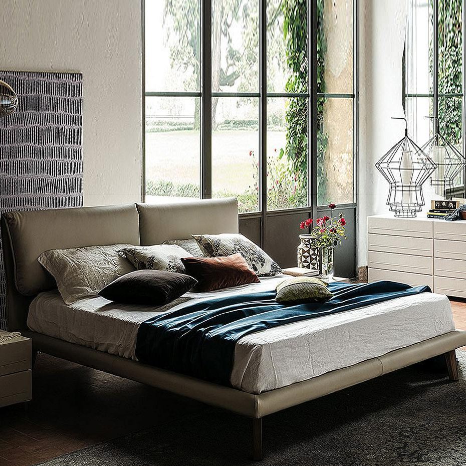 modern platform bed with decorative blue throw.