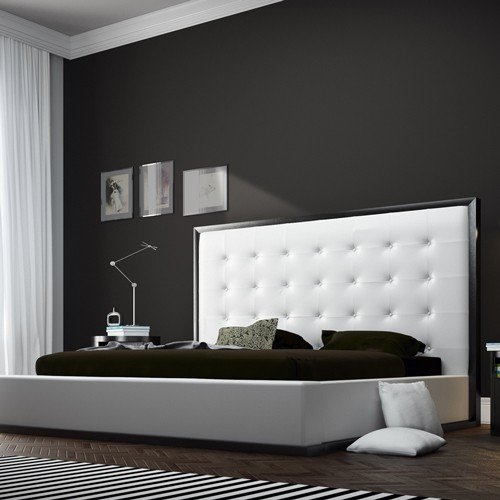 modern black and white bed with large headboard.