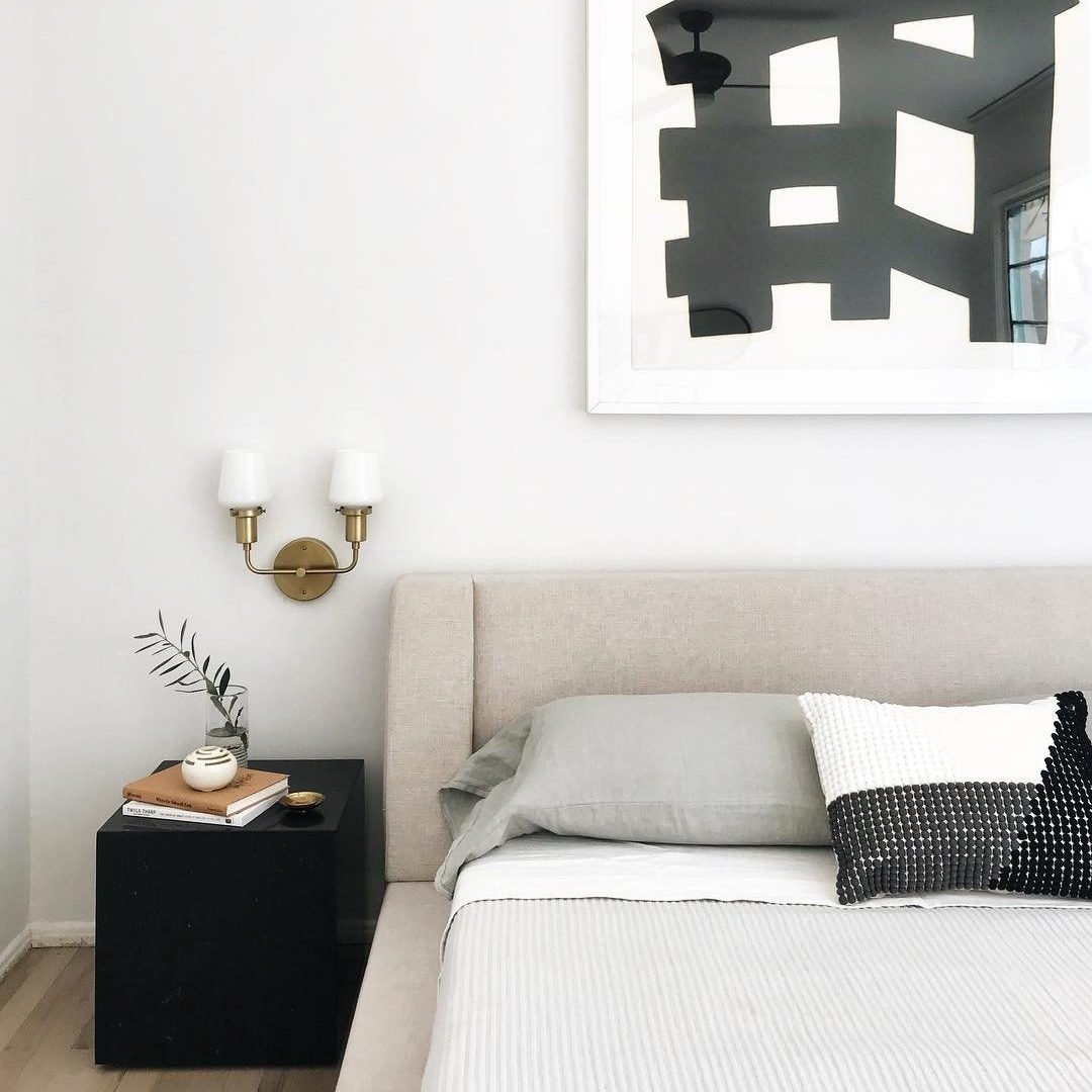 modern and minimal bedroom with wall sconces.