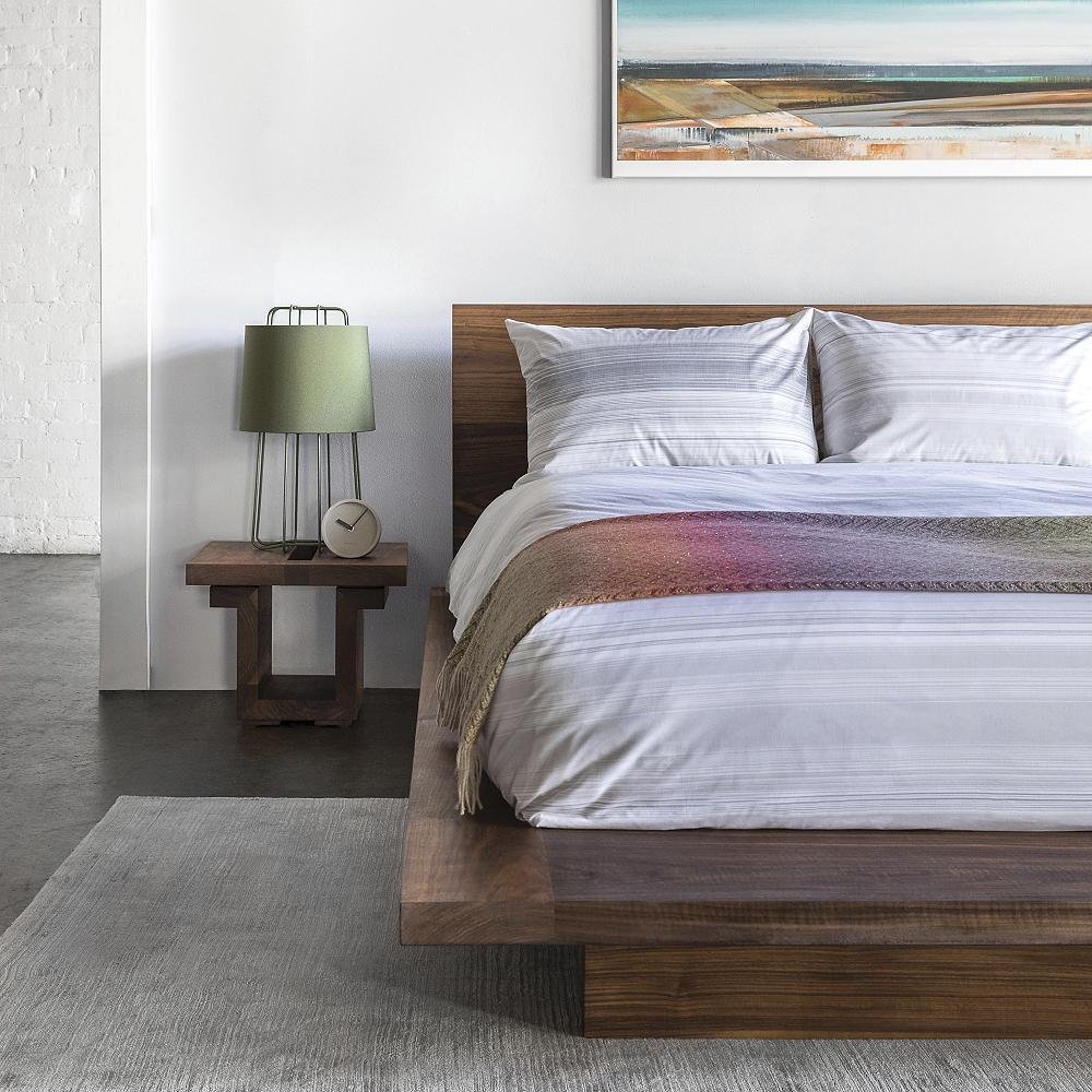 modern wood platform bed and matching nightstand.